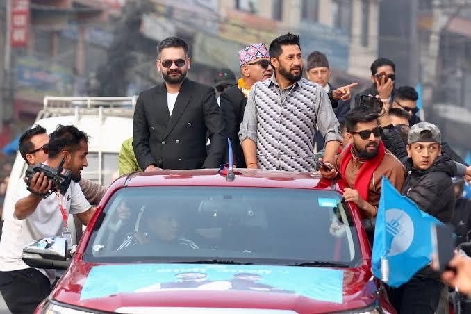 Balen Shah at public rally, standing on vehicle with supporters